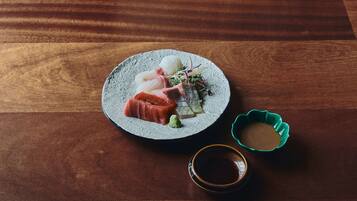 A plate of sushi on a wooden table.
