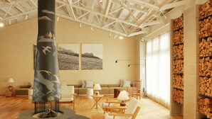 A spacious living area with a fireplace, wooden furniture, and a large window with curtains. - HACIENDA KARUIZAWA HOTEL (Karuizawa)