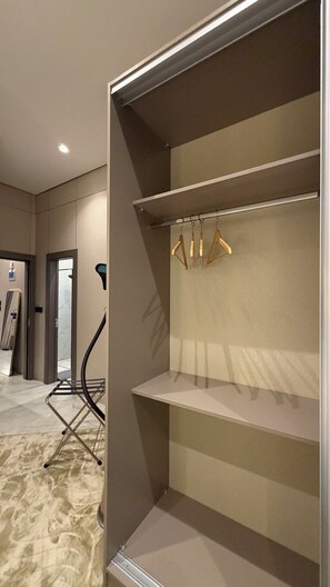 A room with a built-in closet, a mirror, and a chair. - 104 tara-JRE Al Lweibdeh 2BDR with stunning view (Amman)