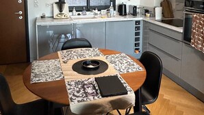 Ett kompakt kök med en matplats, utrustat med en inbyggd ugn, en mikrovågsugn och ett handfat.
