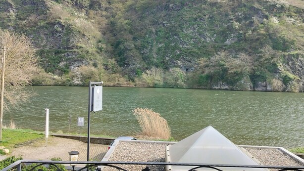 Une vue sur le lac, avec un espace de stationnement et un bâtiment doté d’un toit en pente.