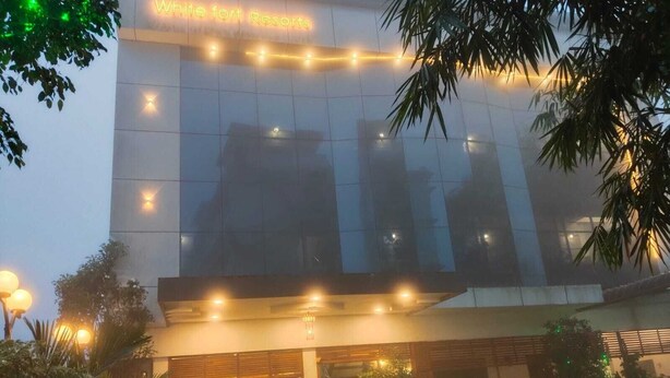 A modern building with a sign reading 'White Fort Resorts.' - WHITE FORT THEKKADY (Kumily)