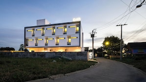 A modern building with illuminated windows and a sign reading 'B48' at the top. - B48 Hotel (Bangkok)