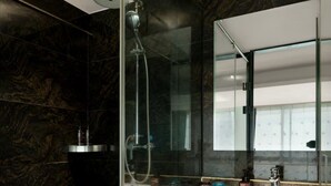 A modern bathroom with a glass-enclosed shower, a large mirror, and a white sink with a beige cabinet. - H Hotel Xi'an Bell Tower Muslim Quarte (Xi'an)