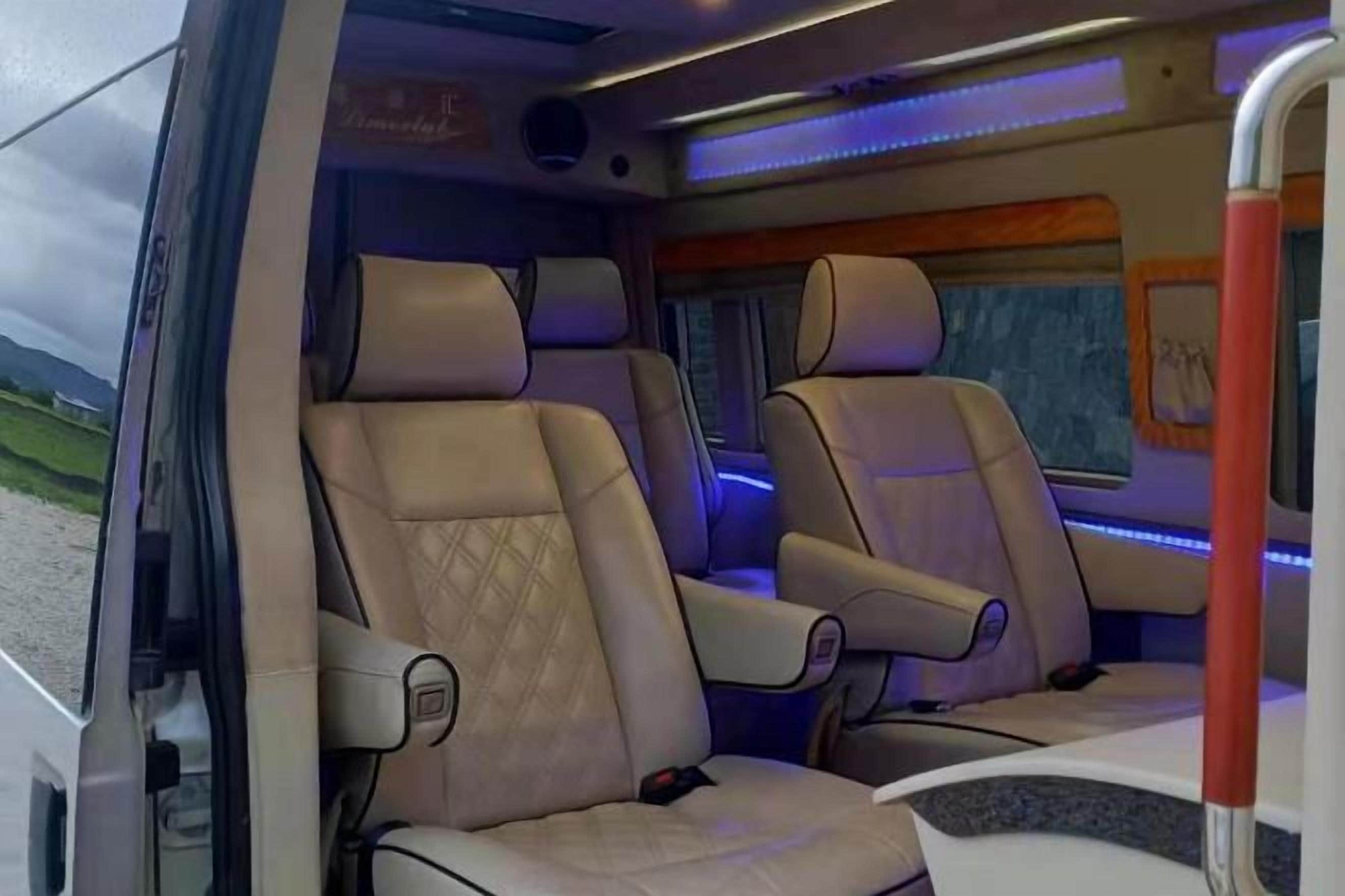 A vehicle interior with two seats, a window, and a door.