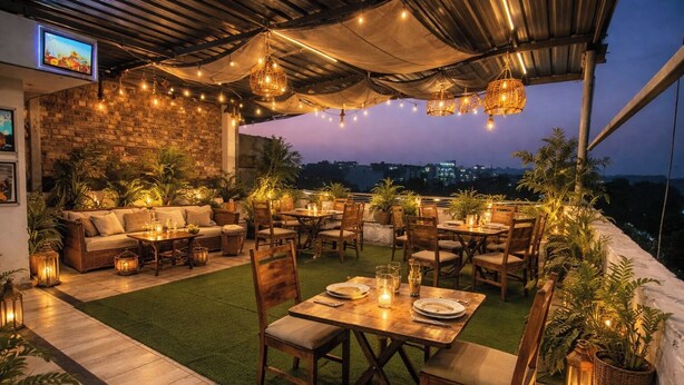 Un patio al aire libre con zona de comedor, asientos y una pantalla de televisión.