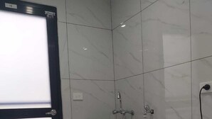 A laundry room with a washing machine, a sink, and a door. - Whitehaven Apartment in Lautoka, Fiji (Lautoka)
