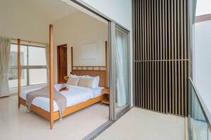 A four-poster bed with a wooden headboard, a bedside table with a vase of flowers, and a sliding glass door leading to a balcony. - ELIVAAS Mirai Gemini 3 BHK Villa (Vagator)