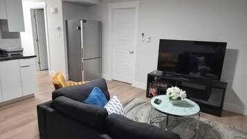 Apartment, 1 Bedroom | Living room | Flat-screen TV
