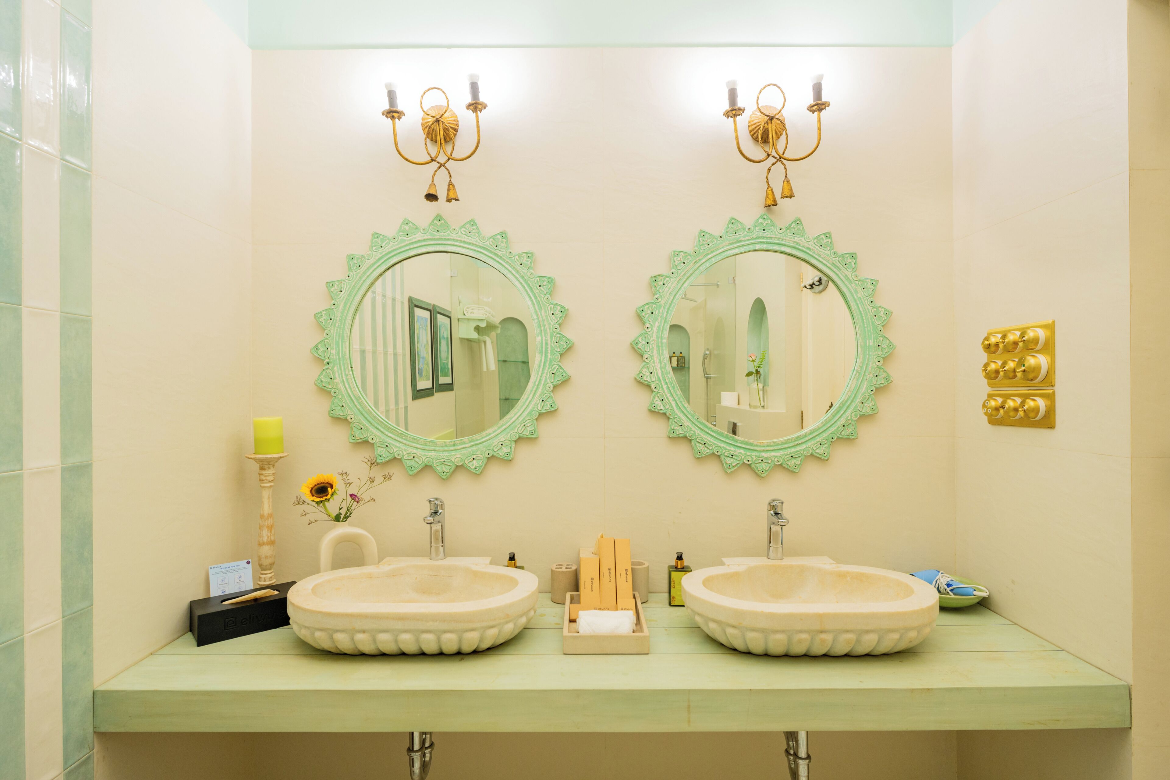 A bathroom with two sinks, a mirror, and a vanity.