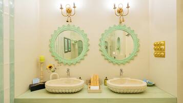 A bathroom with two sinks, a mirror, and a vanity.