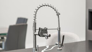 A kitchen with a modern faucet, a sink, and a countertop. - Nick House (Lehigh Acres)