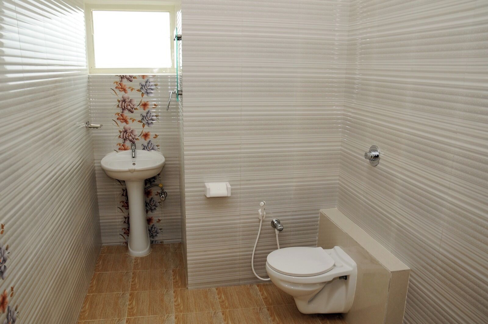 A bathroom with a toilet, sink, and shower.