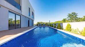 A modern building with a swimming pool, large windows, and a clear sky. - Villa Pinus by Villas Guide (Crvar)