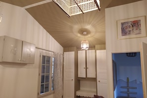 A room with a window, a door, a ceiling light fixture, and a wall-mounted shelf. - Charming gîte with swimming pool south Ardèche L'Oustal (Vesseaux)