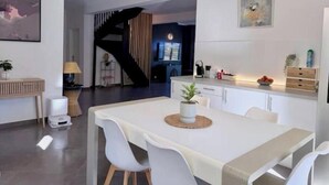 A modern living room with a dining area, a staircase, and a kitchen. - House with pool and jacuzzi in Cagnes-sur-Mer (Cagnes-sur-Mer)