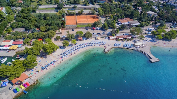 An aerial view of a coastal area with a beach, a pier, and a tennis court. - Modern vacation apartment in Crikvenica with internet, sea view, barbecue (Crikvenica)
