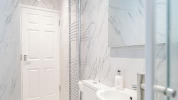 Shower, hair dryer, towels, toilet paper