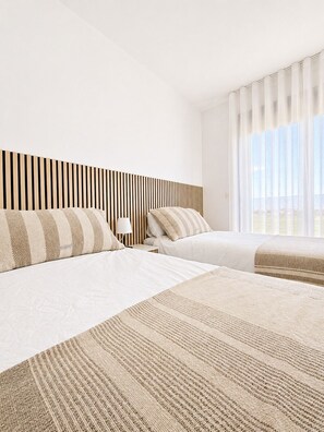 A hotel room with two beds, a striped headboard, a bedside lamp, and a large window with curtains. - Casa Aruna | Private Pool & Rooftop Terracel (San Pedro del Pinatar)