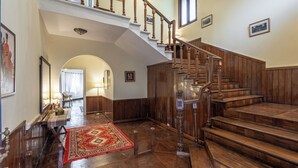 A grand staircase with wooden railings and a red carpet leading to an upper floor. - Alaya Stays Chalet Vie 3 BHK Villa (Kasauli)