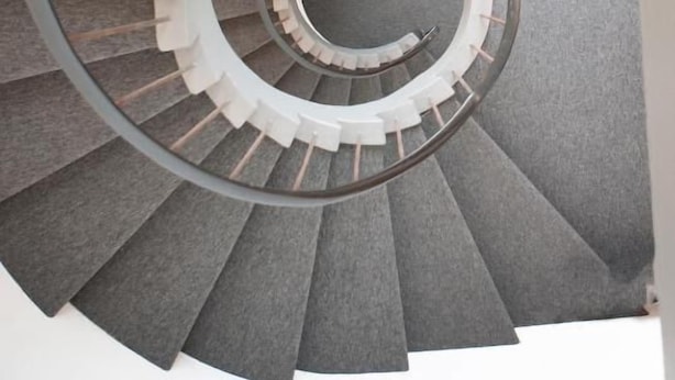 A spiral staircase with a central column and steps radiating outward. - Eiðar Hostel and Apartments (Eiðar)