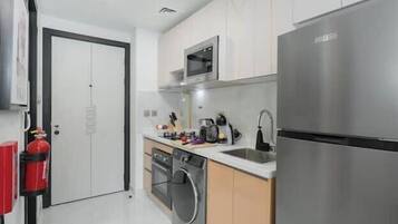 Luxury Studio, Balcony, City View | Private kitchen | Full-size fridge, microwave, oven, stovetop