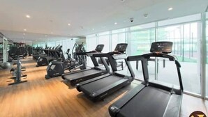 A gym with treadmills, exercise bikes, and other fitness equipment. - Vogue | Skyz by Danube near Dubai Miracle Garden (Dubai)