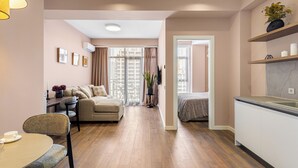 A modern apartment with a living room, dining area, kitchenette, and a bedroom. - HB apartments Jikia Residence (Tbilisi)