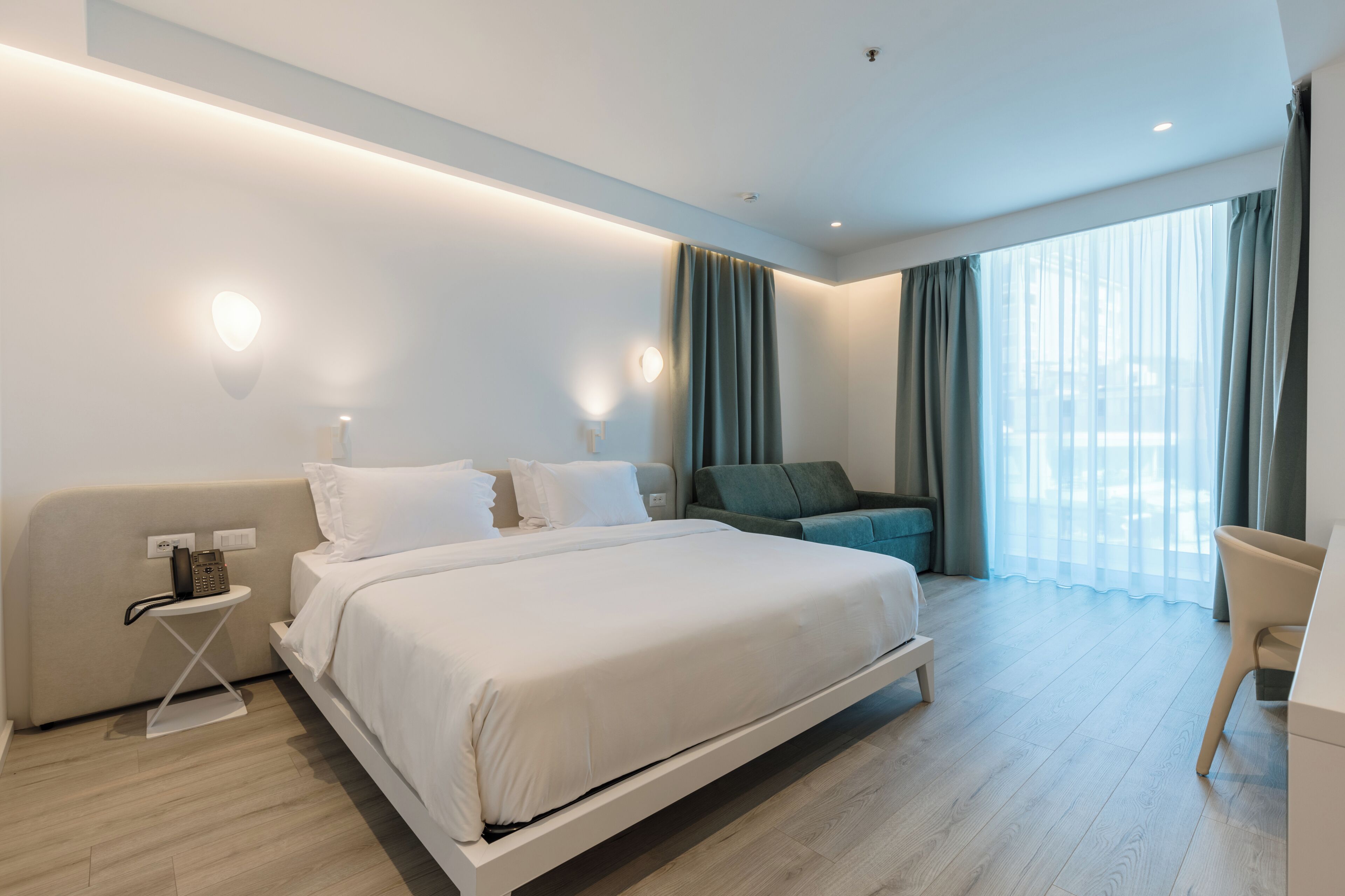 Superior Double Room, Partial Sea View | Minibar, in-room safe, desk, laptop workspace
