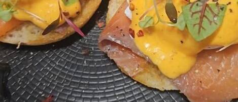A plate with food items, including a slice of lemon and a garnish.