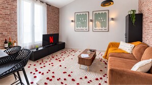 A modern living room with a TV, sofa, and coffee table.