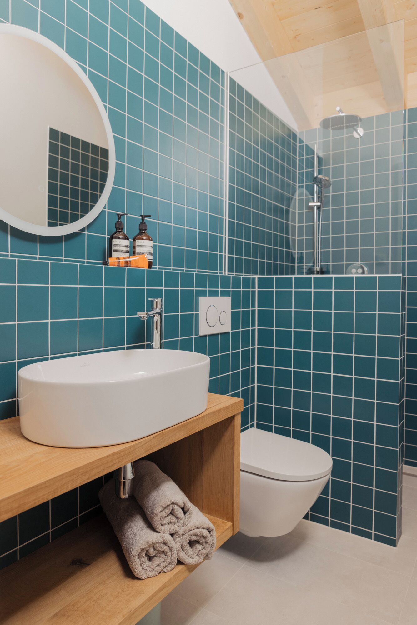 A bathroom with a white sink, a toilet, and a shower.