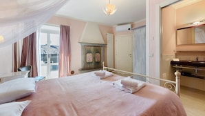 A bedroom with a bed, bedside tables, a mirror, and a window with curtains.