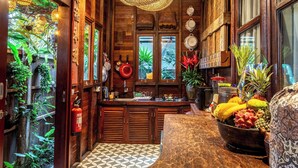 A wooden ceiling, a kitchen with a wooden countertop, and a dining area with a table. - Airlangga Dsawah by Balihora, Ubud Vill (Ubud)