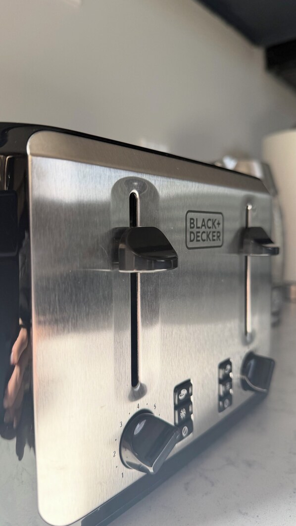 A metallic kitchen appliance with a label 'BLACK+DECKER.'