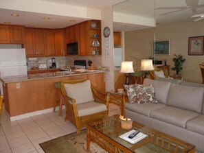 A compact living space with a kitchenette, a sofa, a coffee table, and a dining area. - Napili Point Oceanfront Turtle View 1br - Unit B30 1 Bedroom Condo (Lahaina)
