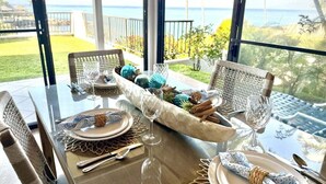 A dining table set with plates, cutlery, and a centerpiece. - Oceanfront Family Friendly 2br Maui - Unit B29 1 Bedroom Condo (Lahaina)