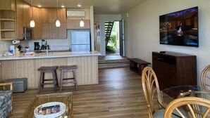 A modern kitchen with wooden cabinets, a central island, and a ceiling fan. - Oceanfront Condo Near Napili Bay 1br - Unit B19 1 Bedroom Condo (Lahaina)