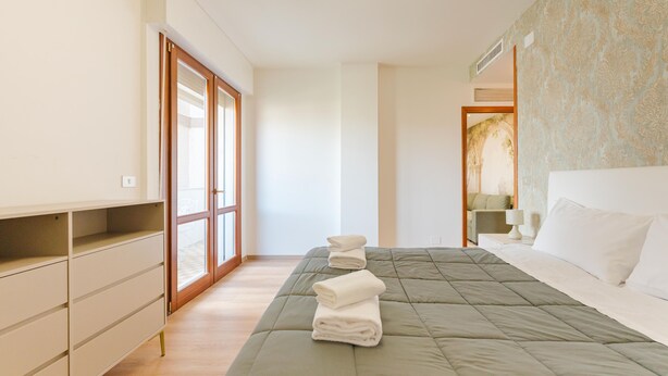 Une chambre à coucher avec un lit, une armoire et une fenêtre.