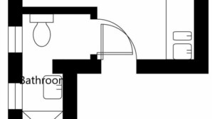 Un studio comprenant une salle de bain avec des toilettes, un lavabo et une douche.