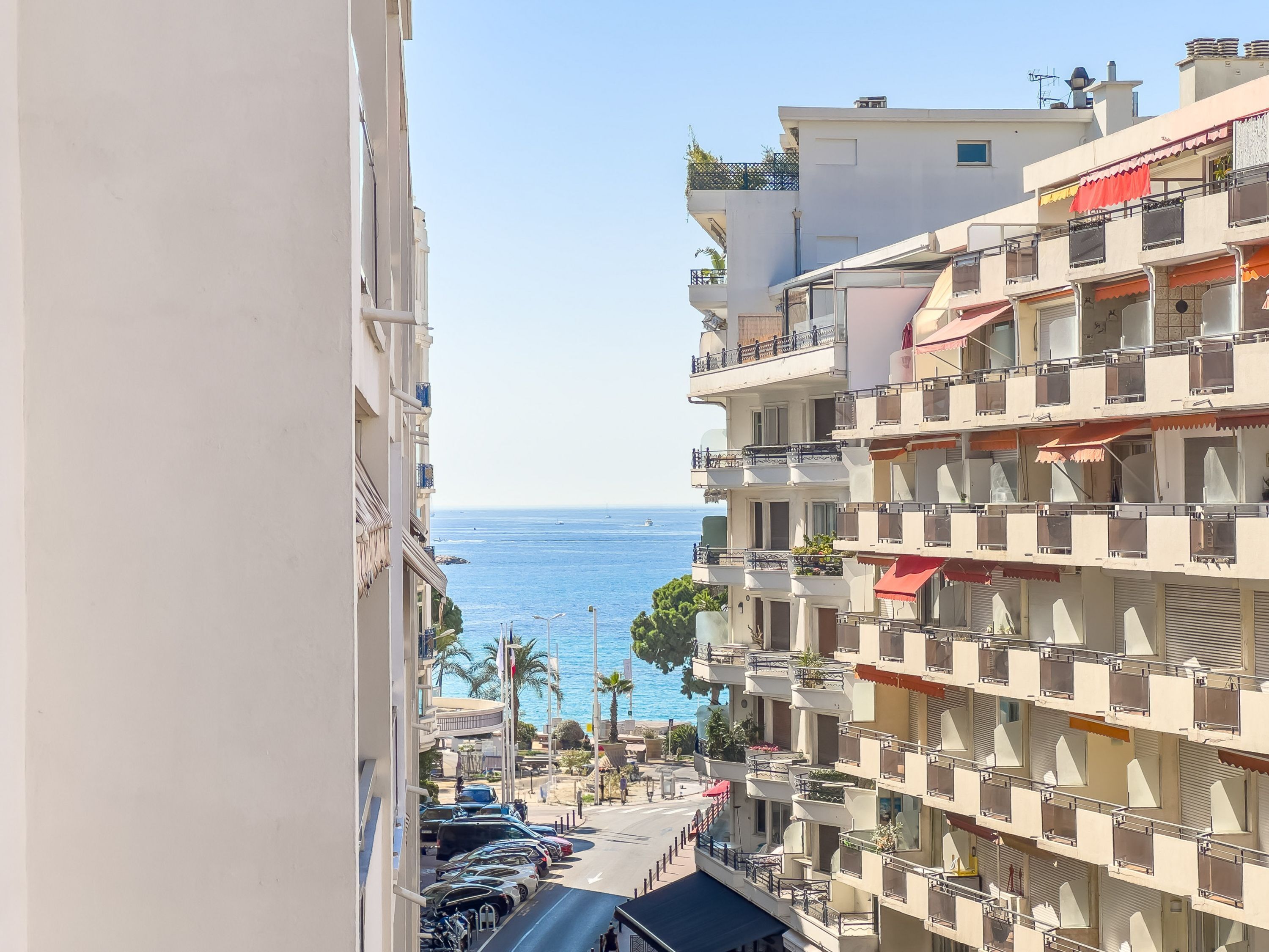 A multi-story building with balconies overlooking a coastal area.