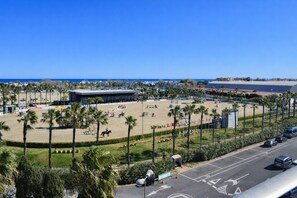 A coastal sports complex with a large open field, palm trees, and a modern building. - Anacasa Albatros MET Oliva Nova Golf AT469 (Oliva)