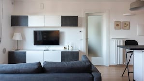 A modern living room with a flat-screen TV, grey sofa, and minimalist decor. - Nolo Flat - Metro Turro & Wi-Fi (Milan)