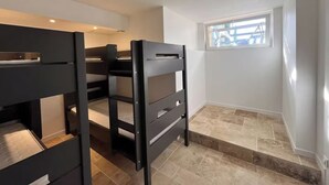 A room with bunk beds, a window with a view, and a tiled floor. - Villa sleeps 10 with heated pool & jacuzzi and breathtaking views (Coux and Bigaroque-Mouzens)