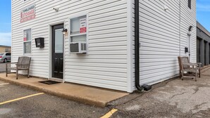 A storage facility with a sign for Tumbleweed Storage, a mailbox, and an employee parking sign.