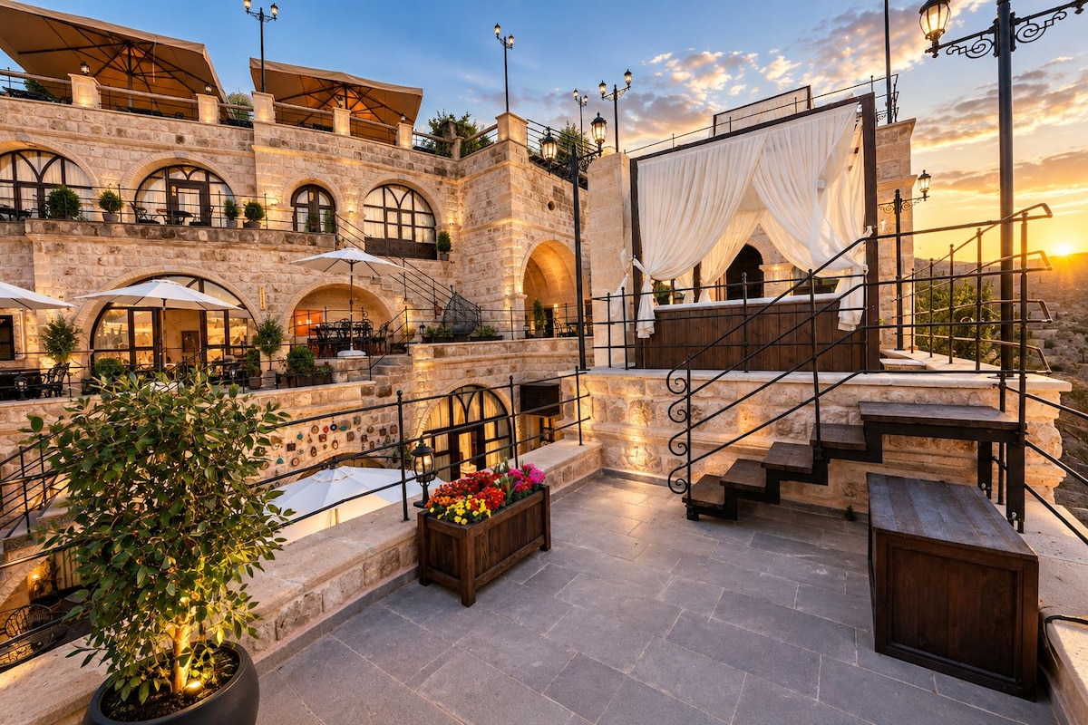 A stone building with outdoor seating and a staircase.
