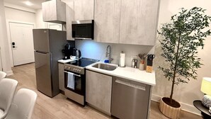 A modern kitchen with stainless steel appliances, a built-in oven, and a dishwasher. - Spacious Center City 2BR 2Bath Apt. with Balcony (Philadelphia)