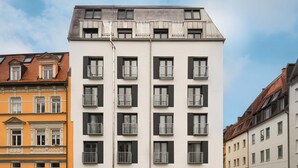 A modern multi-story building with a flat roof, large windows, and balconies. - Limehome Munich Theresienwiese (Munich)