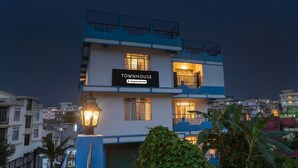 A multi-story building with a sign reading 'TOWNHOUSE' and balconies. - Super Townhouse Howell Crossway Shillong (Shillong)