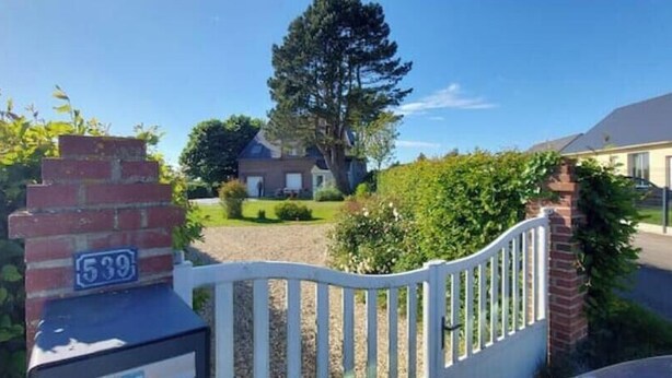 A residential property with a brick entrance gate, a number sign '539', and a well-maintained lawn. - Charming house with swimming pool (Tourville les ifs)